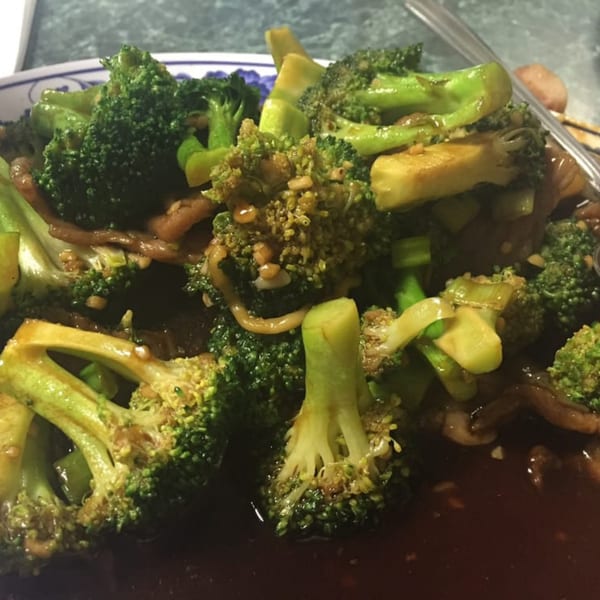 Close-up of Mei Hon Chinese Restaurant's broccoli with brown sauce, featuring green florets and stems.